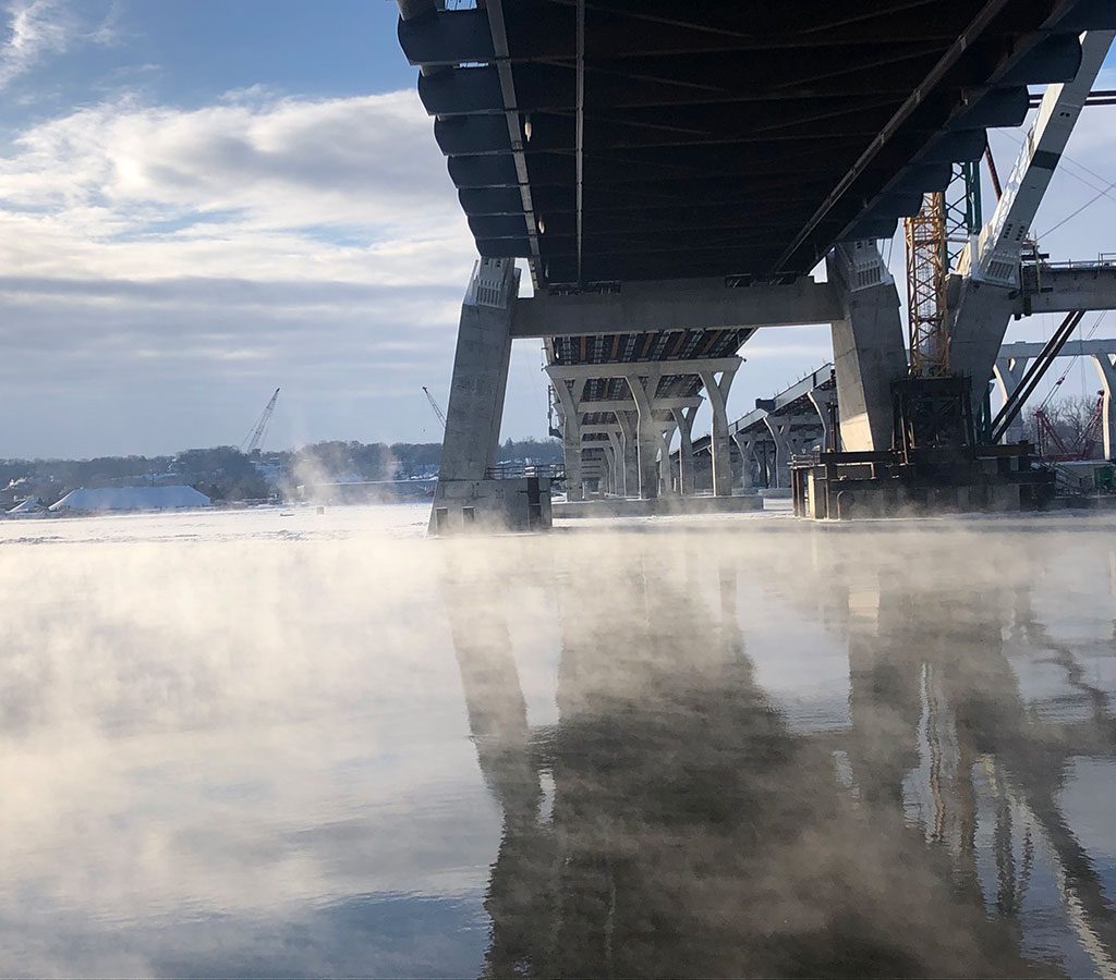 underside of I74 bridge reflecting on the foggy Mississippi River